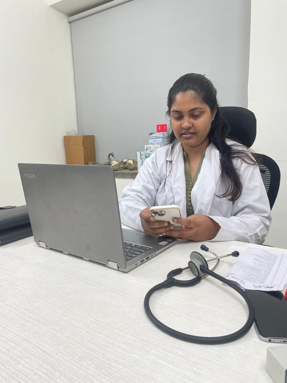 a girl set on chair with laptop and medical tool.